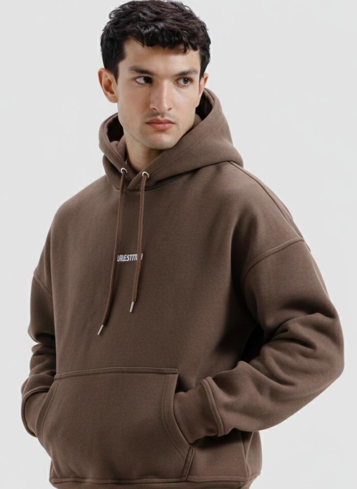 Man wearing a brown hoodie on a light gray background