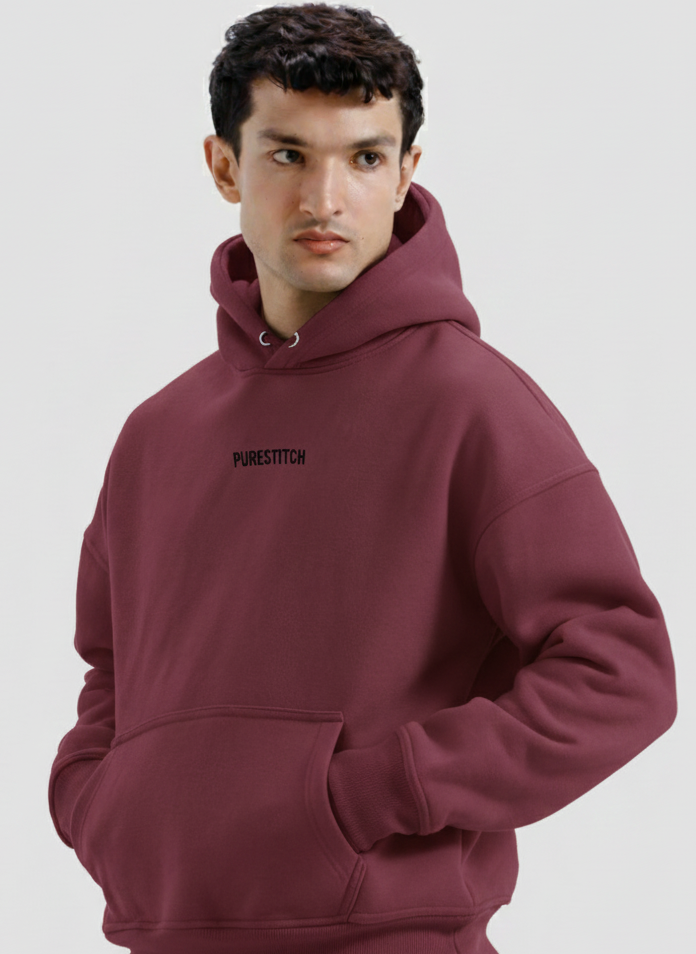 Man wearing a maroon hoodie with text on a light gray background