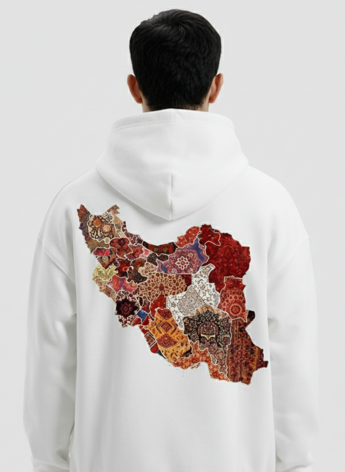 Person wearing a white hoodie with a colorful map design on the back against a white background