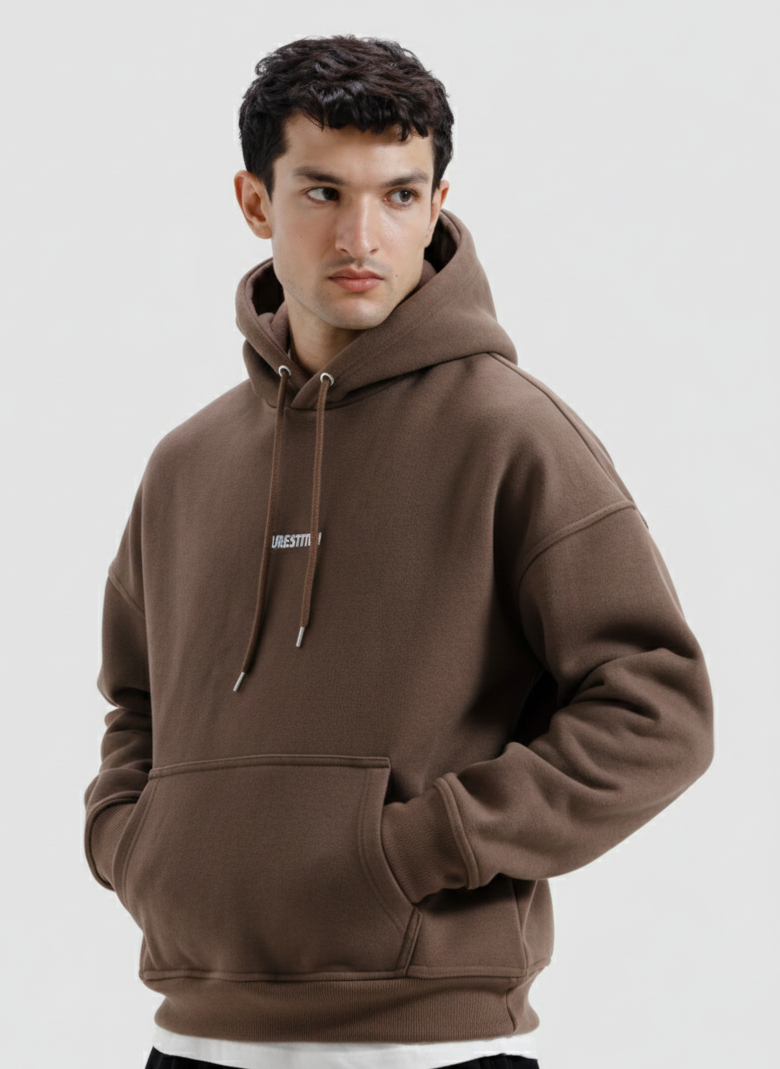 Man wearing a brown hoodie on a light gray background