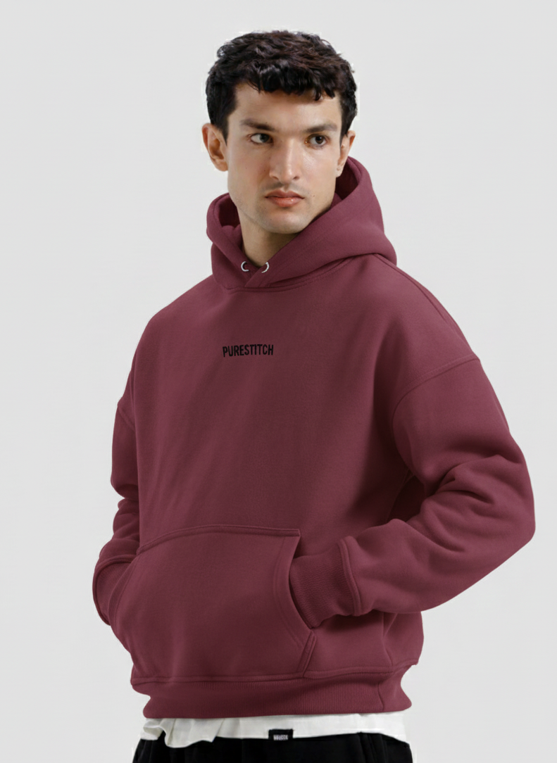 Man wearing a maroon hoodie with text on a light gray background